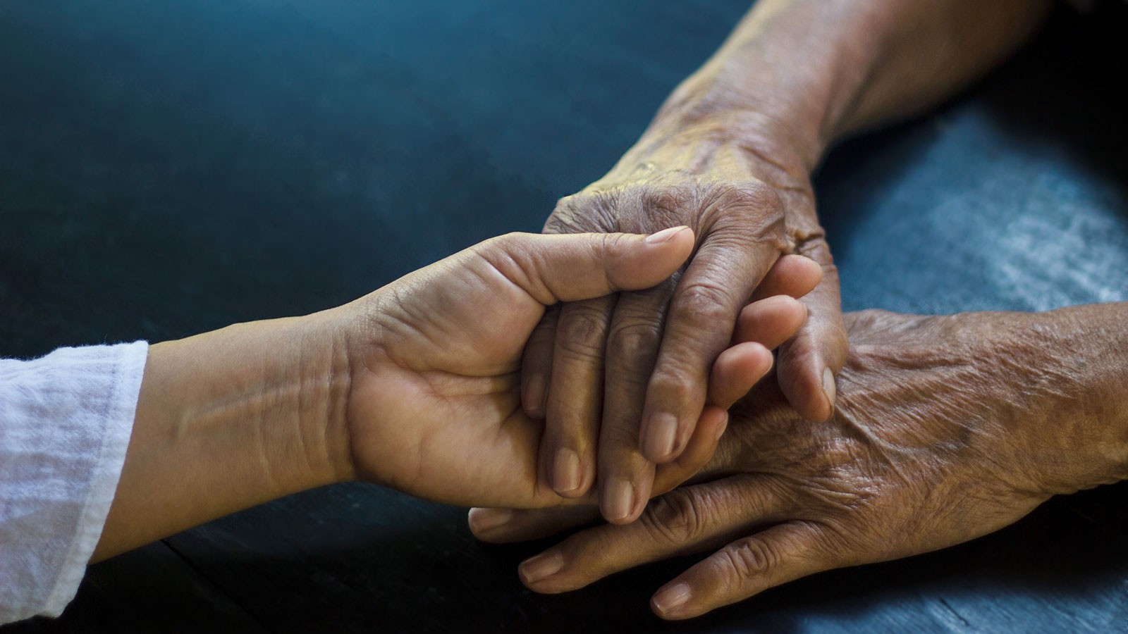 Two people hold hands.