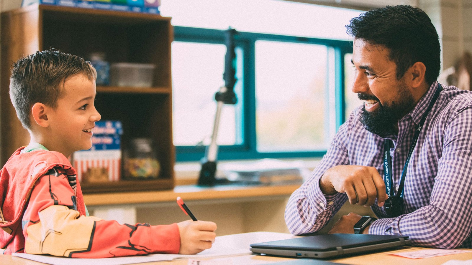 A teacher working with a student.