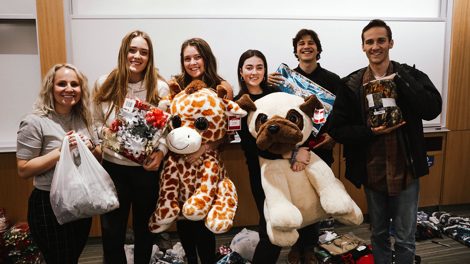Students holding Christmas presents.