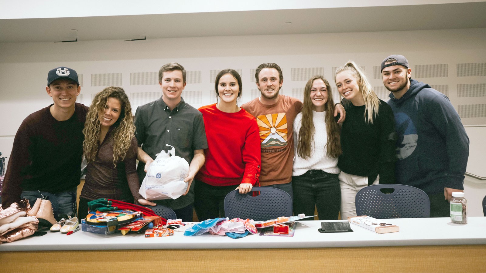 Students holding Christmas presents.