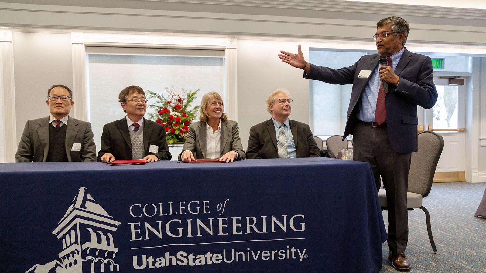 University officials at a table.