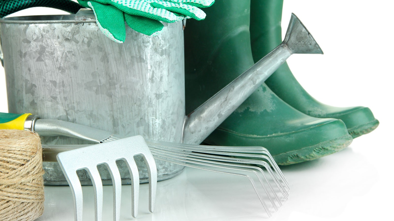 This image shows gardening tools, including rubber boots, a watering can, gloves and more.