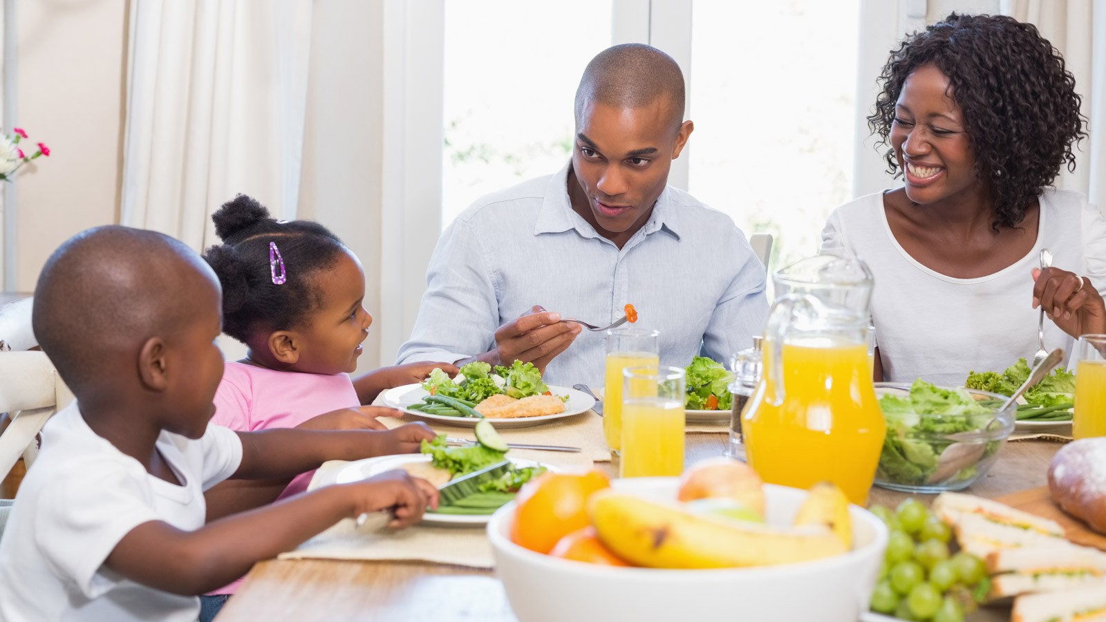 A family sits around the dinner table.