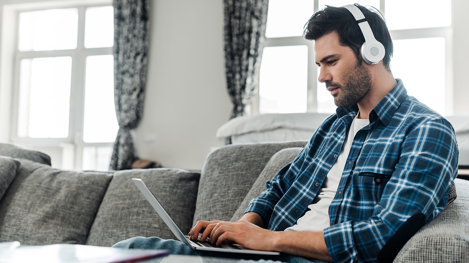 A person typing on a laptop at home.