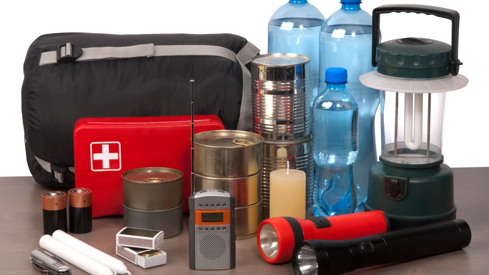 An emergency preparedness kit shows items like a sleeping bag, first aid kit, food and water.