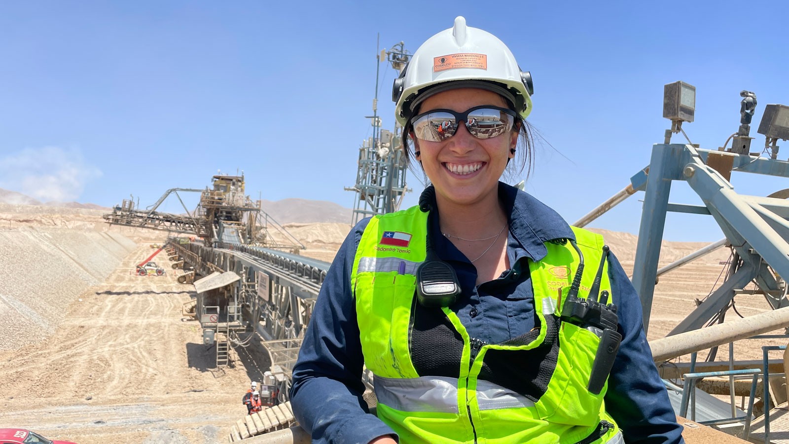 A woman in industrial protective equipment at a copper mining facility.