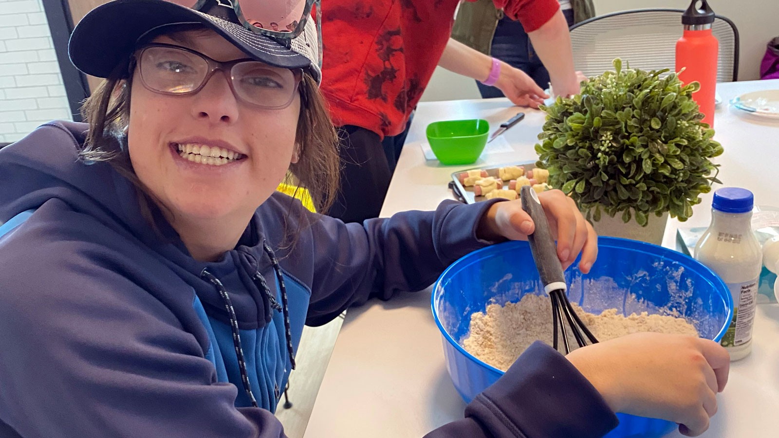 A person whisks ingredients in a bowl.