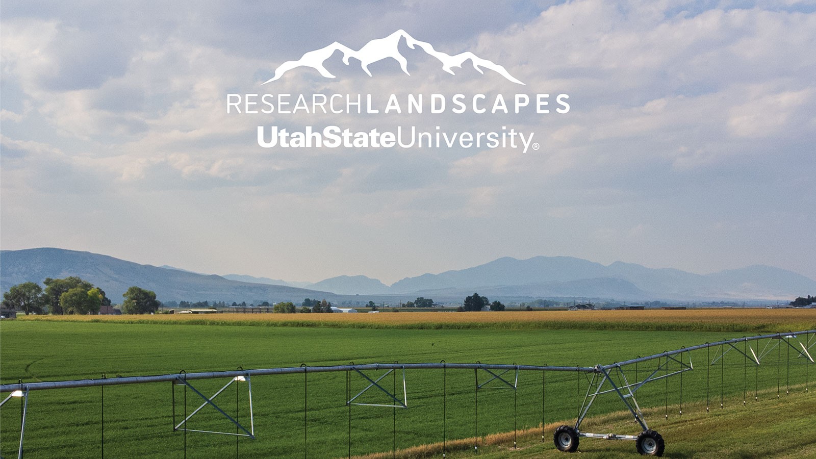 An irrigation line rests on a field. Text reads: Research Landscapes. Utah State University.