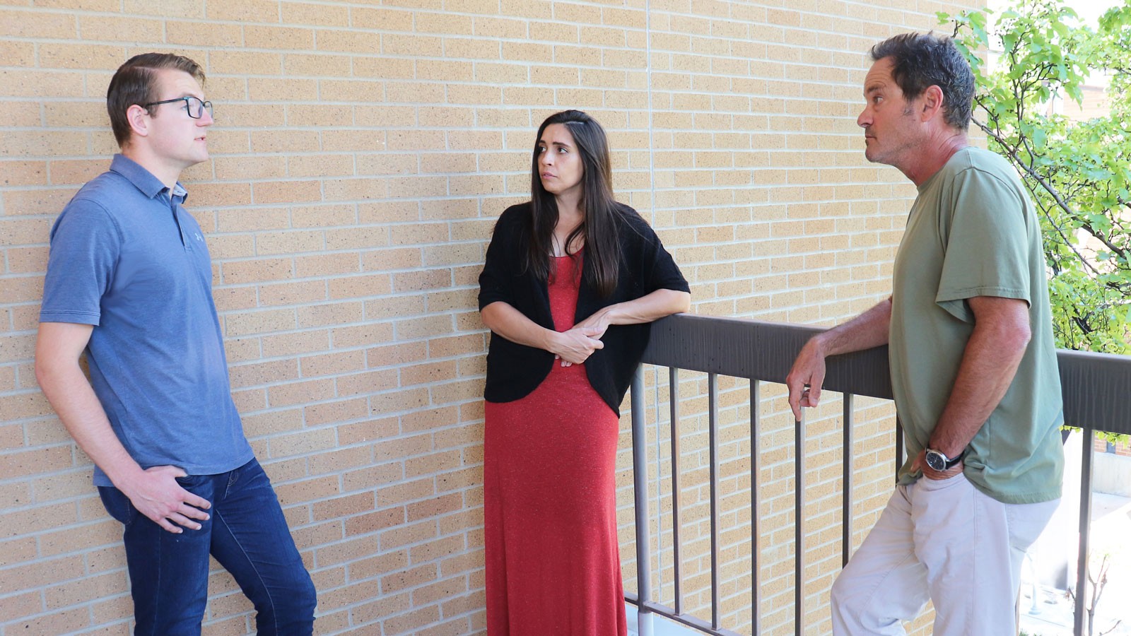Zachary Zito speaks with Brittany Gentry and Charlie Torre in an outdoor space at USU.