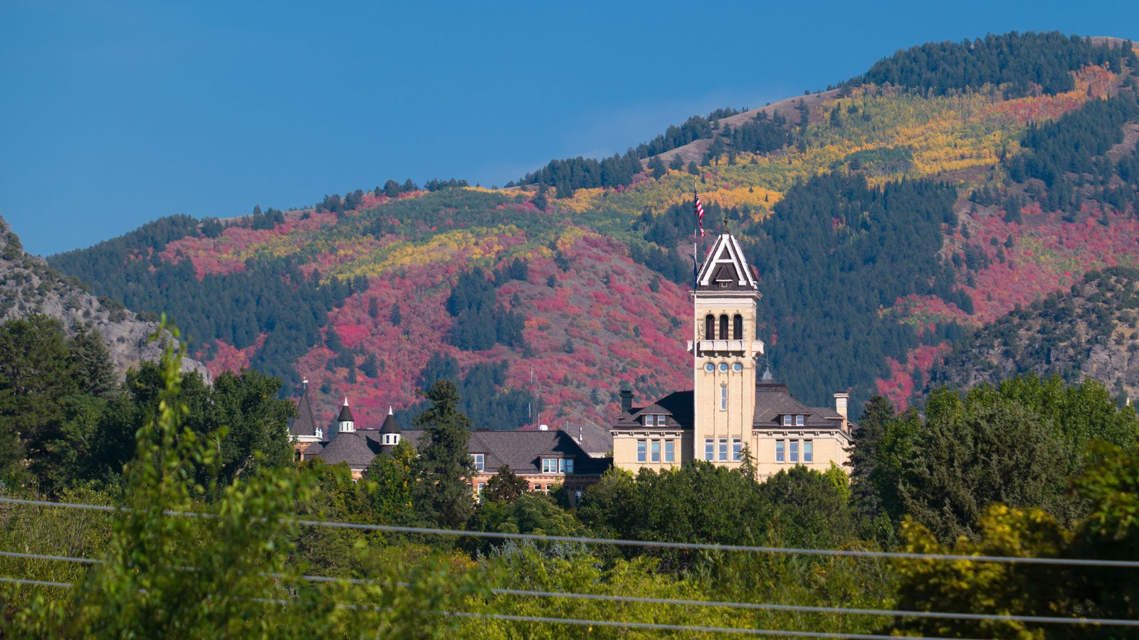Old Main against fall colors on the hillside.