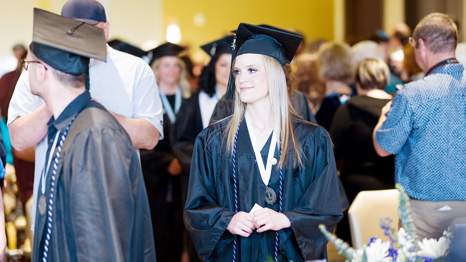 A female graduate approaches the graduation stage