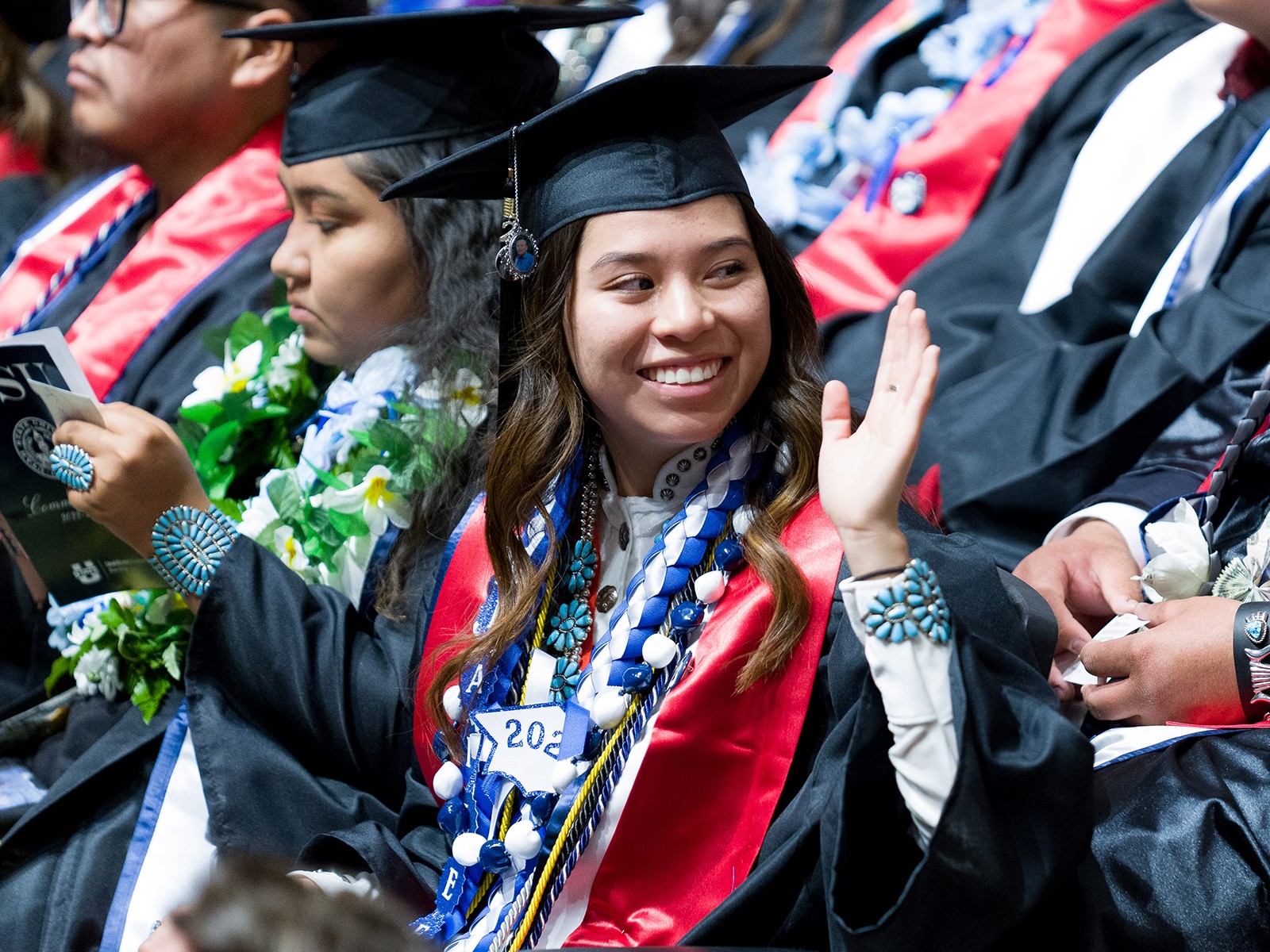 Graduate waves while seated