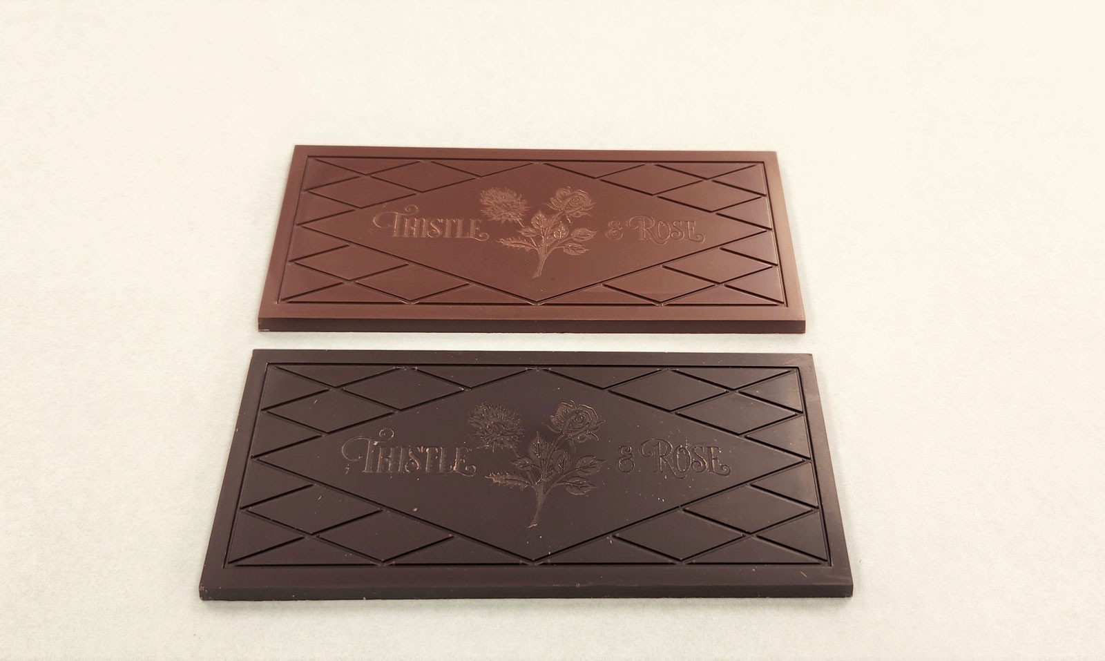 A chocolate bar next to a slightly darker bar.