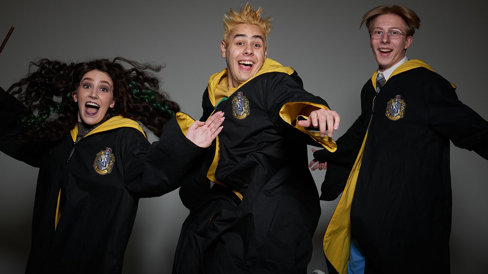 Three actors in wizard robes.