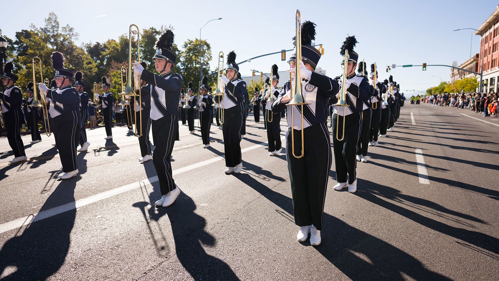 The USU marching band on a street.