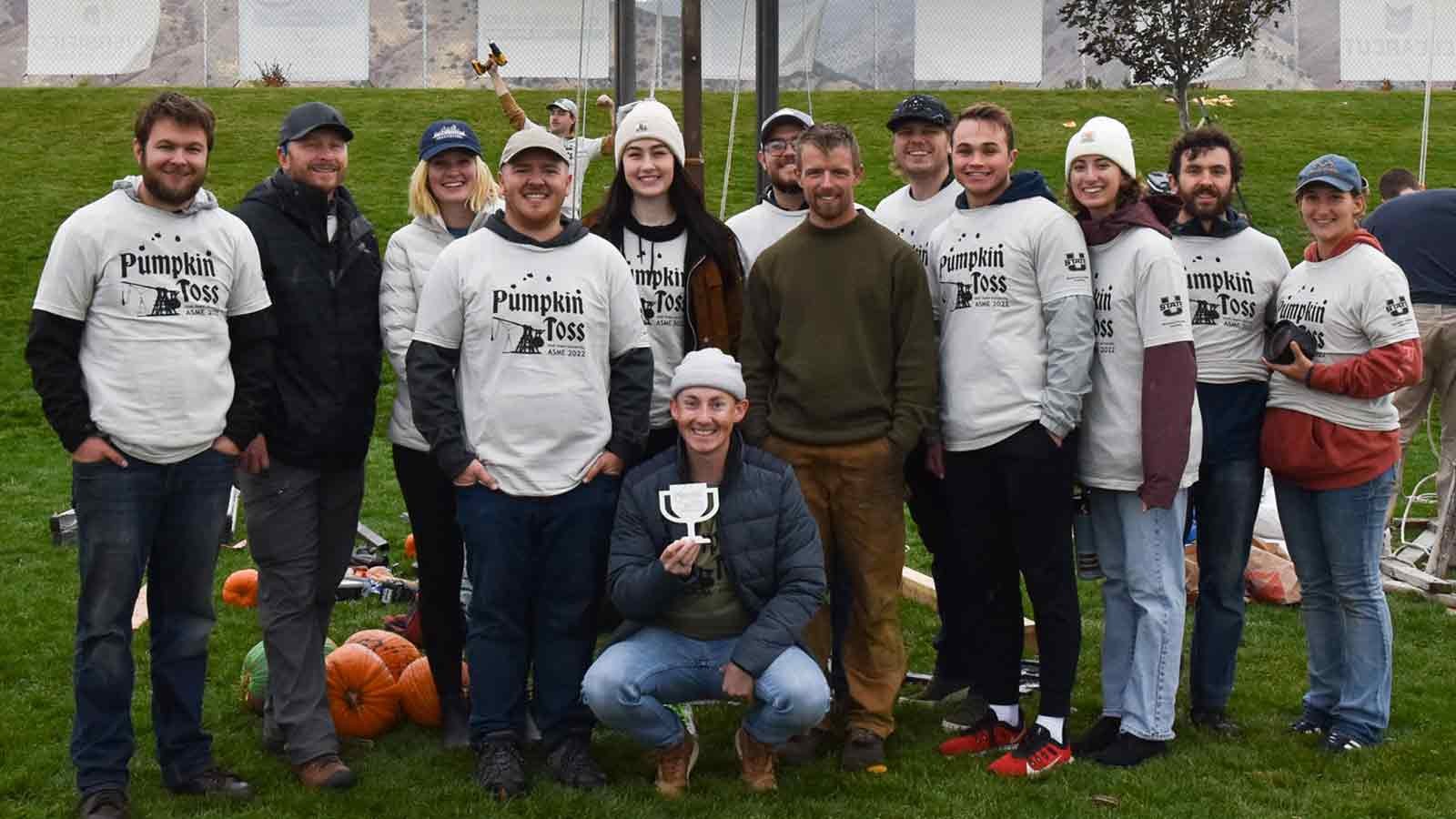 People wearing T-shirts that read "Pumpkin Toss."