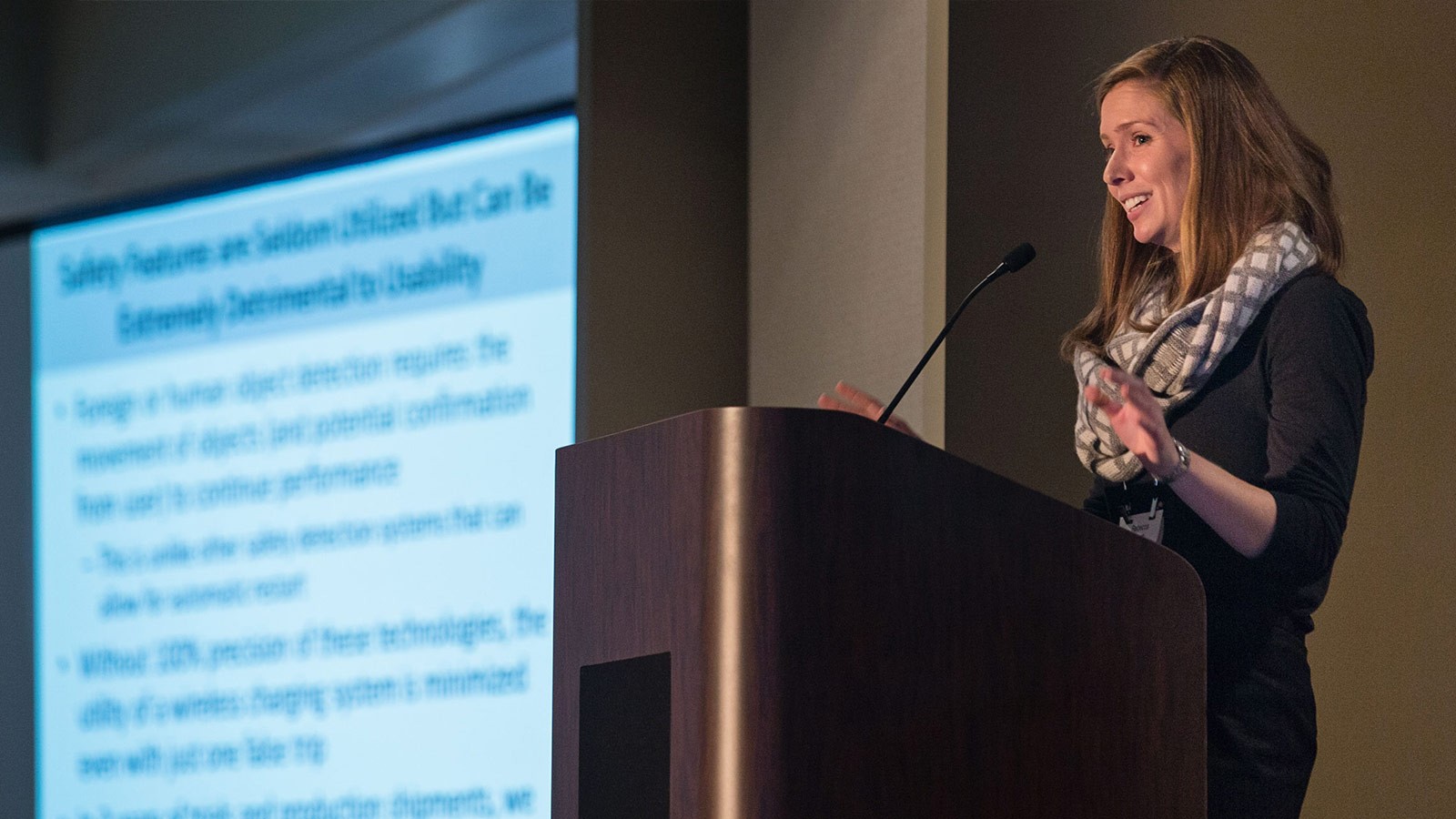 A woman speaking at a conference.