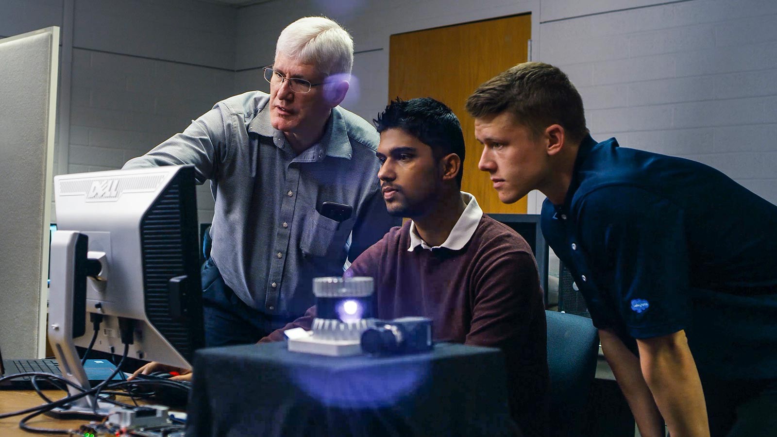 Researchers at a computer testing electronic equipment.
