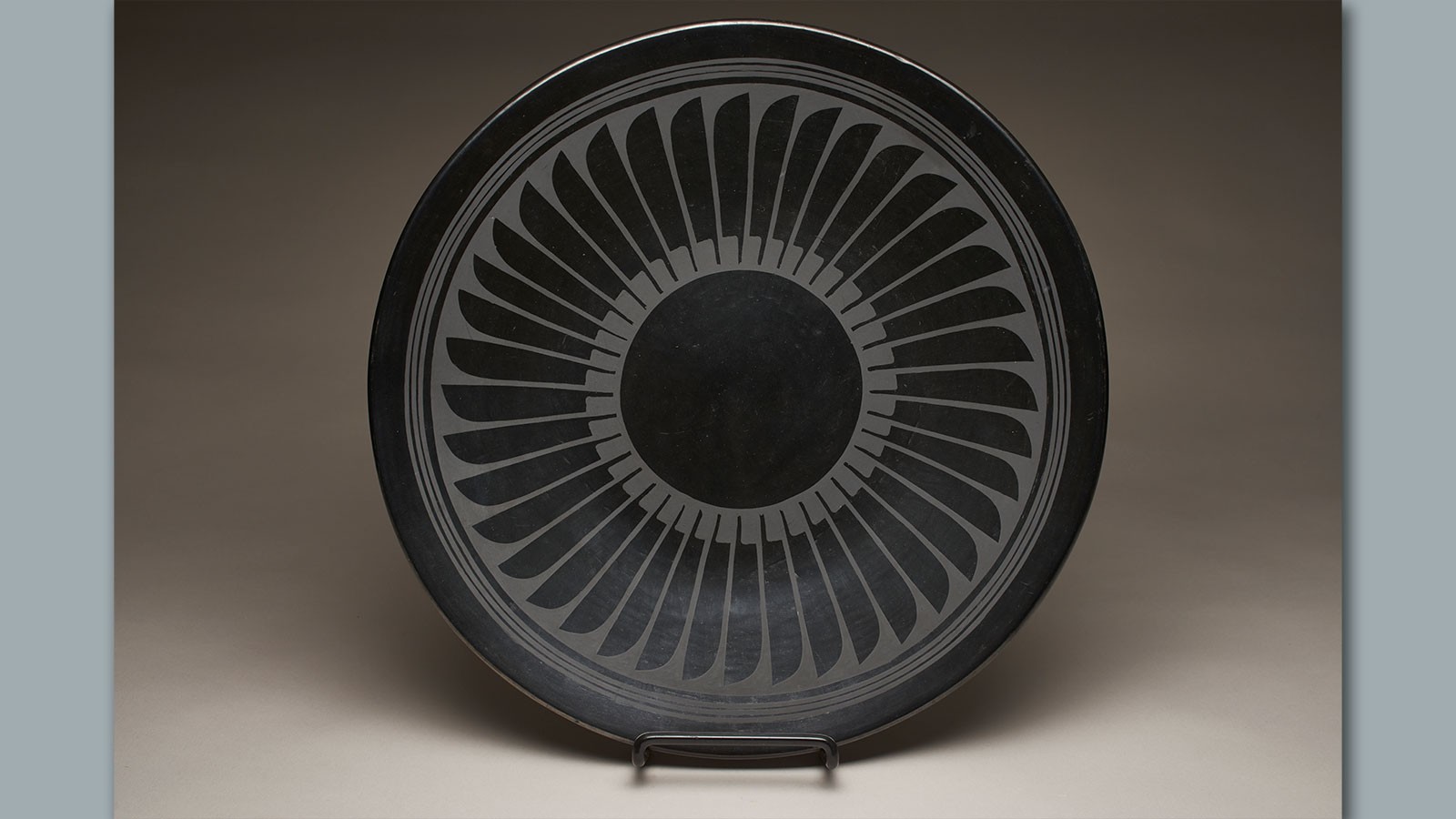 A ceramic plate with feather motifs.