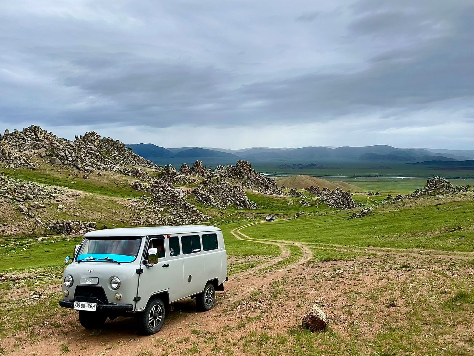 Vans on a mountainous road.