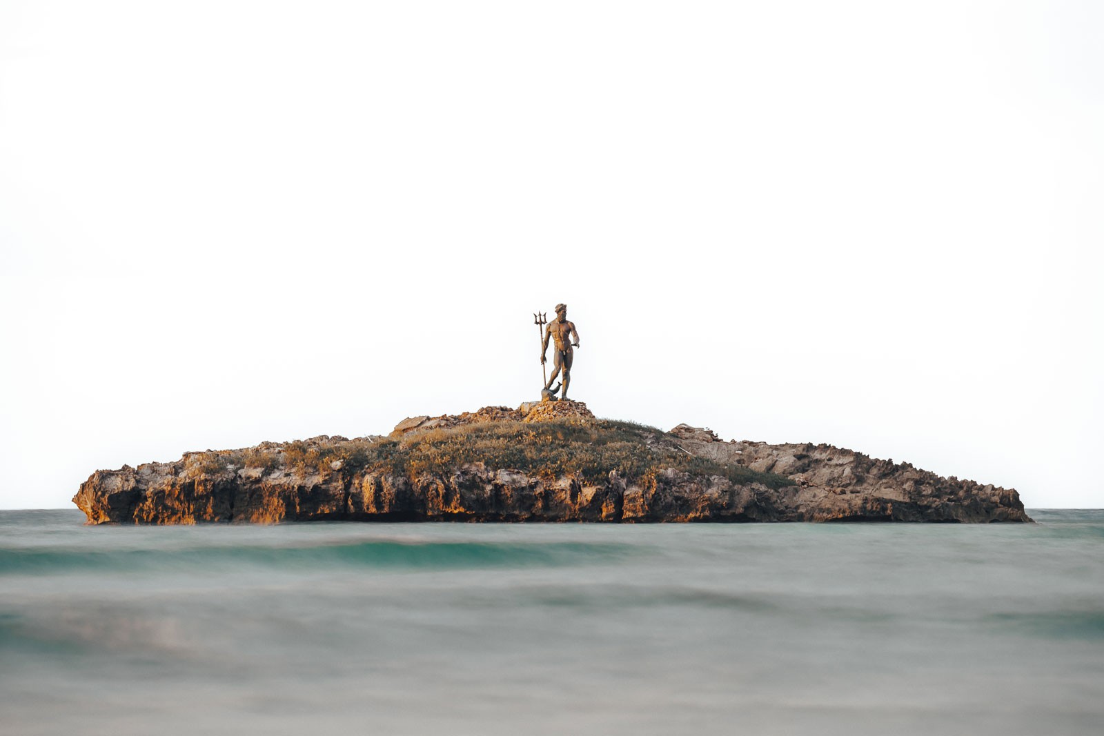 A statue standing on a small island.