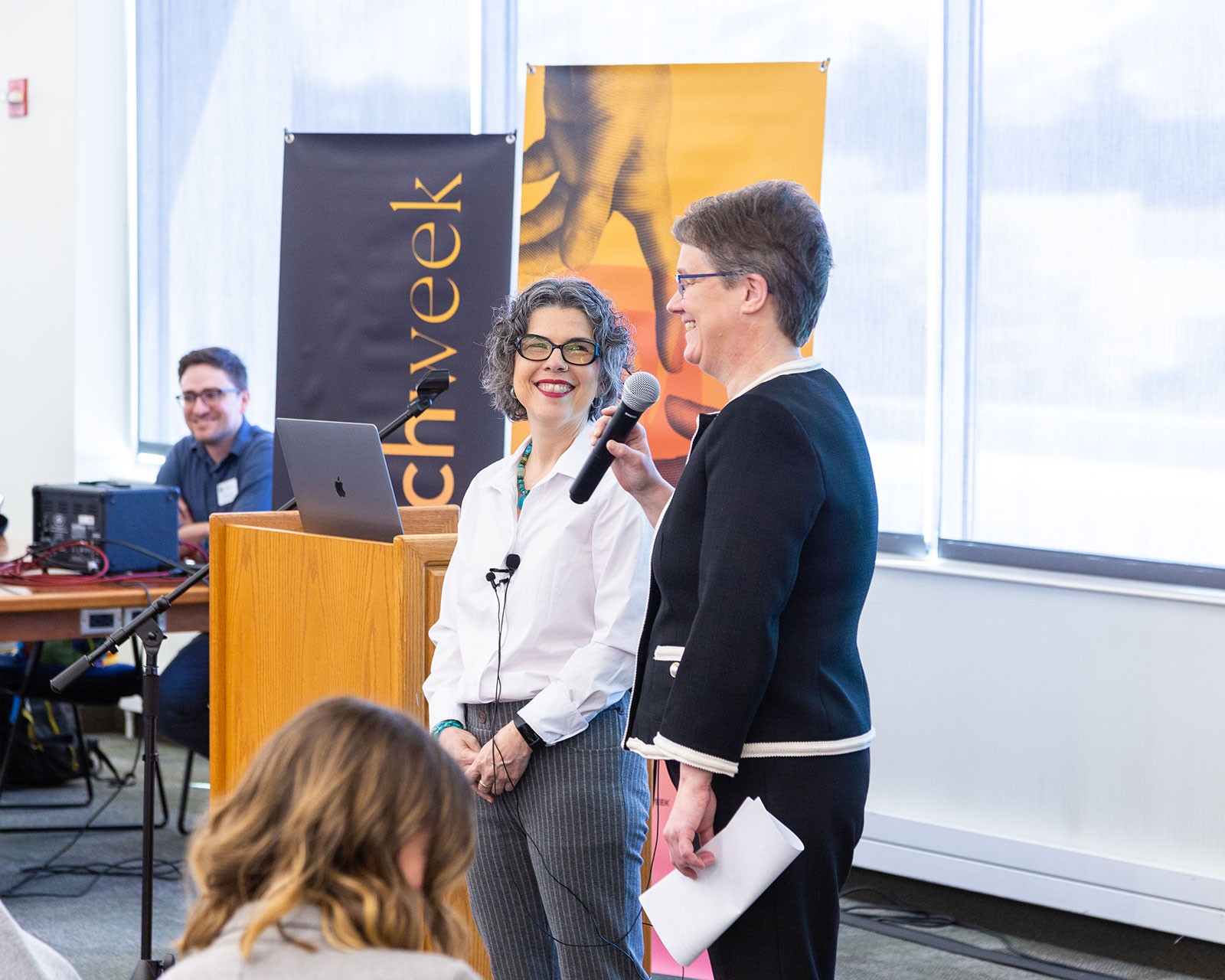 People speaking at an event.