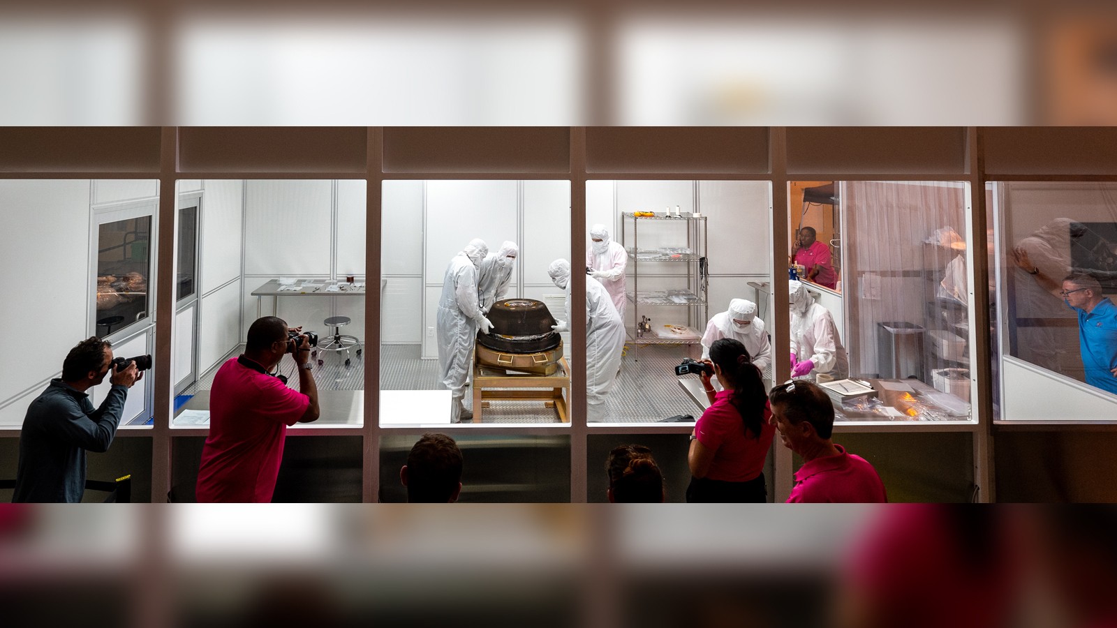 Scientists examine a sample in a lab.