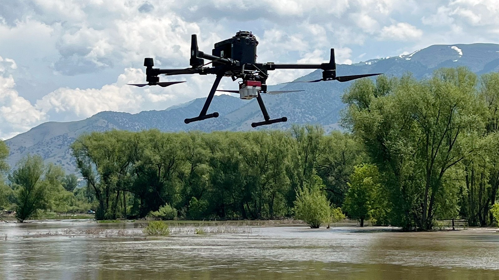 A drone hovering over the Logan River.