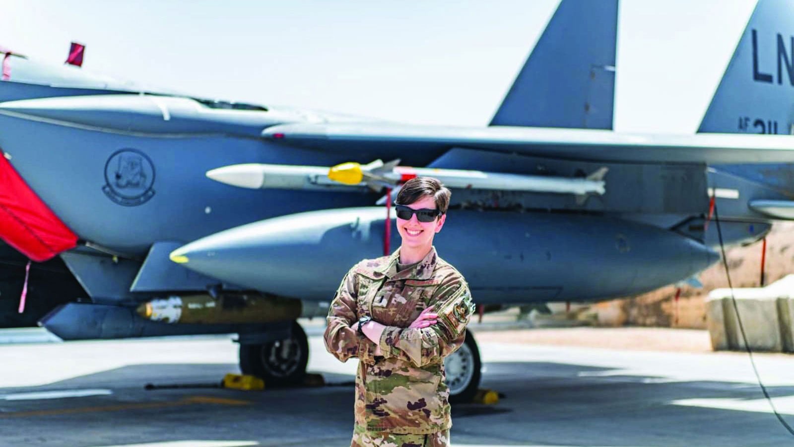 Isabella Muffoletto in front of a fighter jet.
