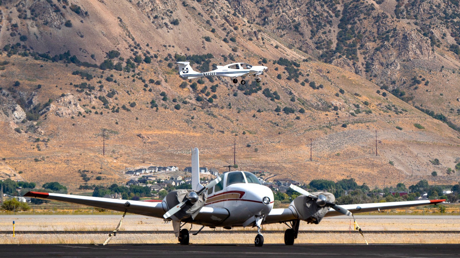 A Utah State airplane over the runway in Brigham City.