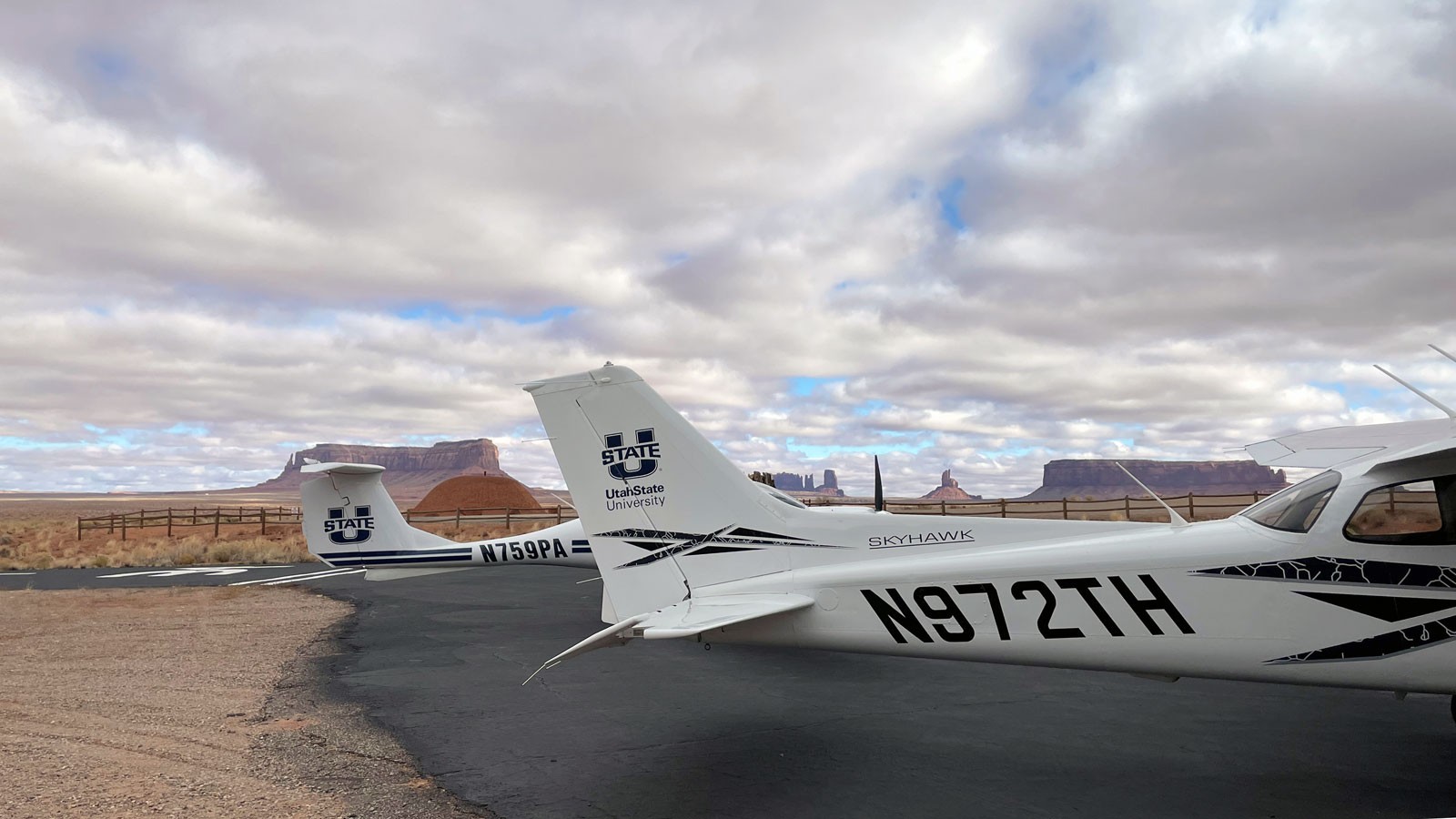 Two USU airplanes at an airstrip in the American southwest.