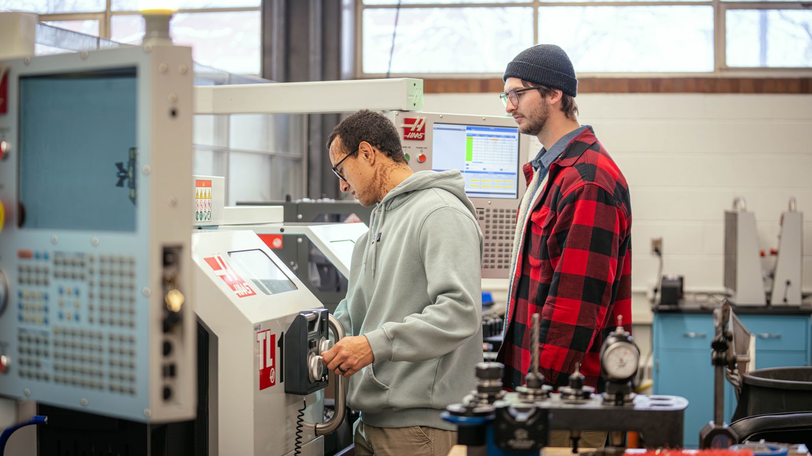People using manufacturing equipment.