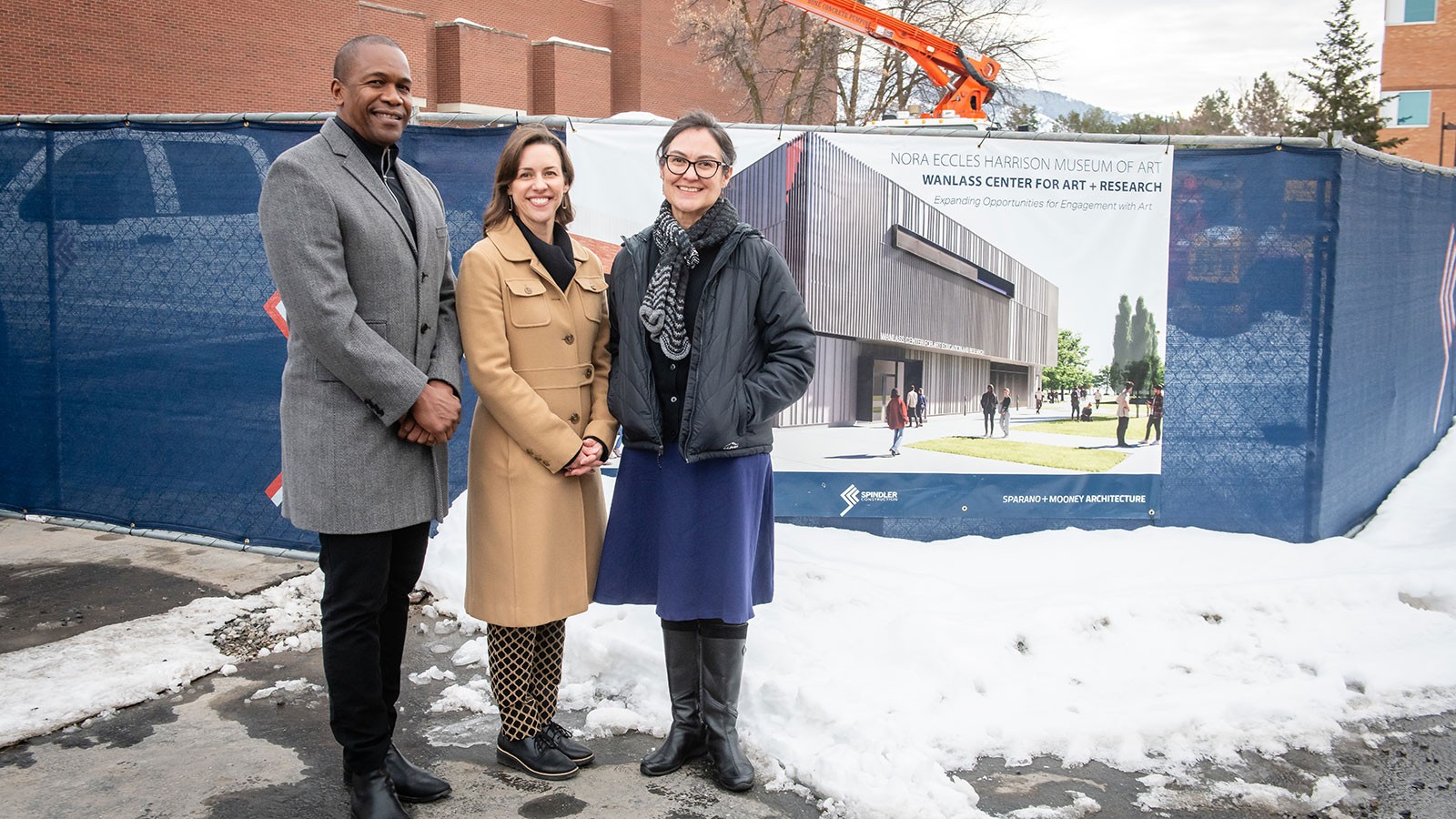 People standing in front of a construction site.