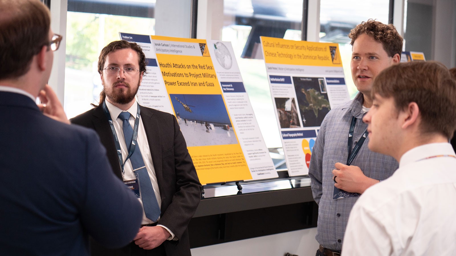 People discuss a research poster.