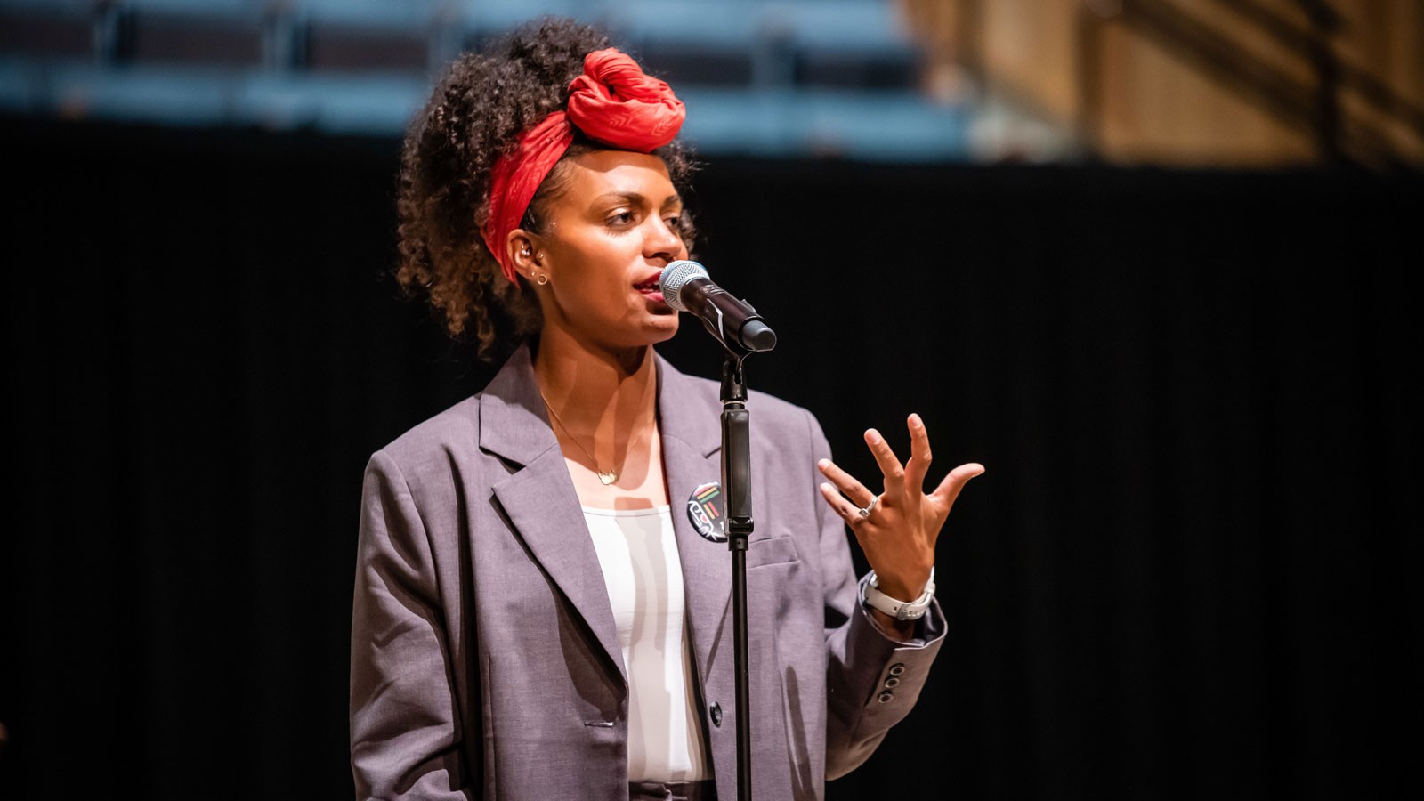 Cree Taylor speaking at a microphone.