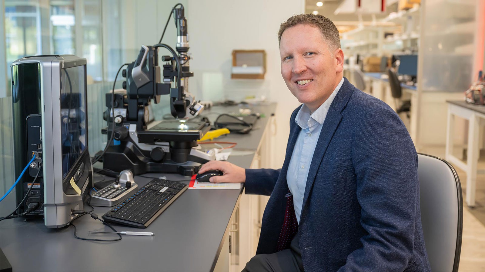 Matt Draper sitting at a microscope.