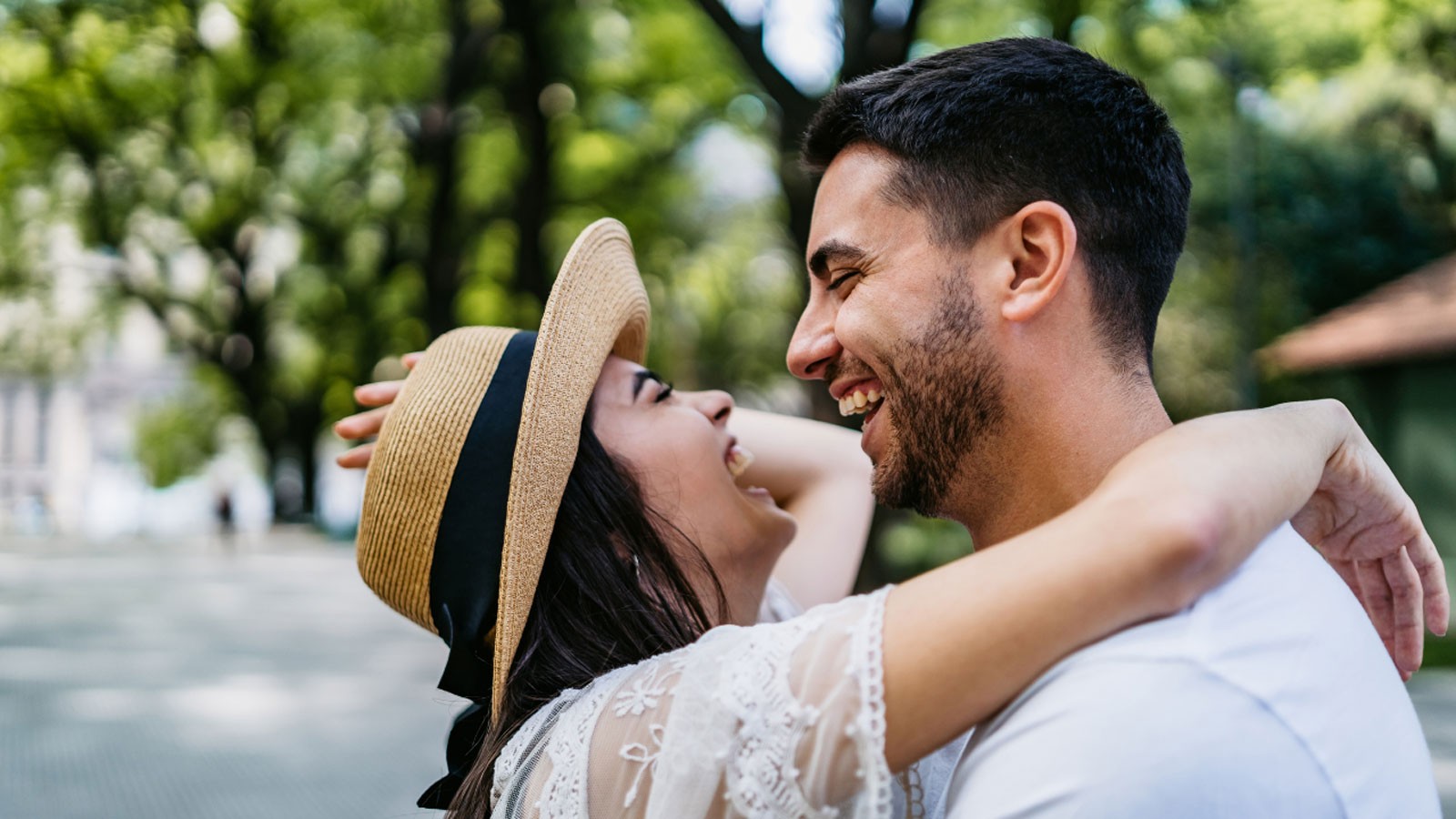 Two people embrace while laughing.