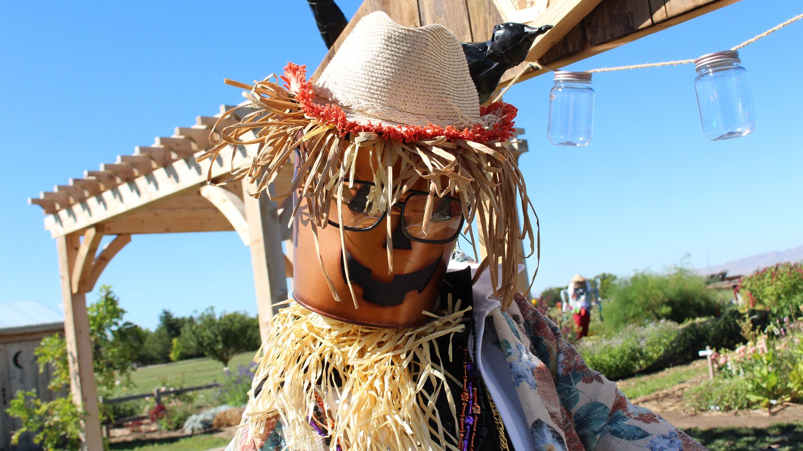 A scarecrow with a painted bucket for a head.