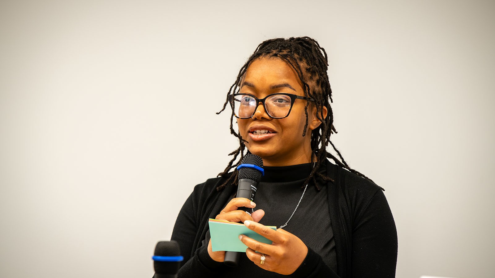 A woman speaks into a microphone
