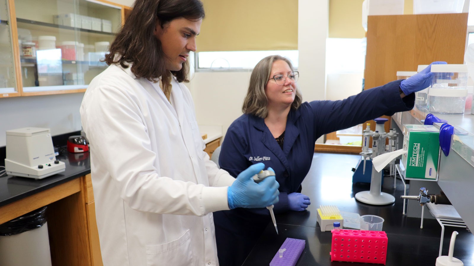 Researchers at a lab bench.