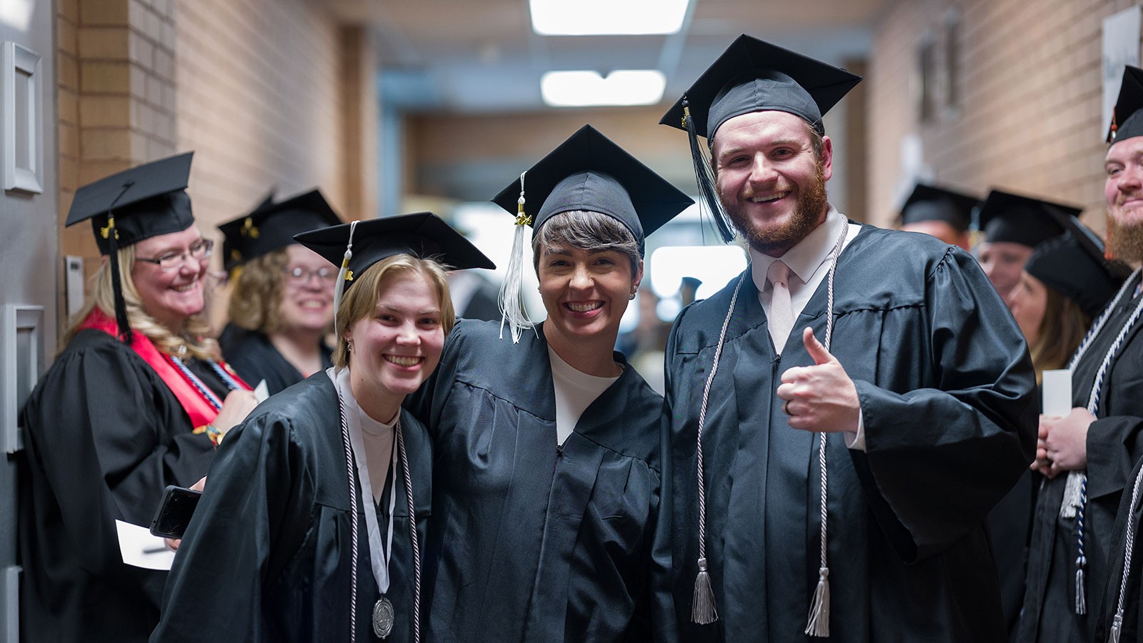 People in graduation robes.