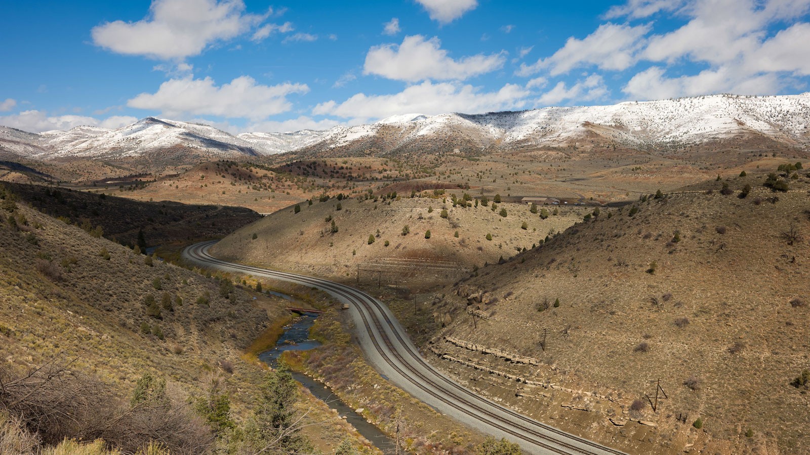 A railroad running through a mountain area.