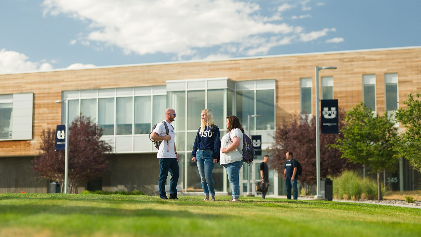 Students stand outside the student center at USU Tooele.