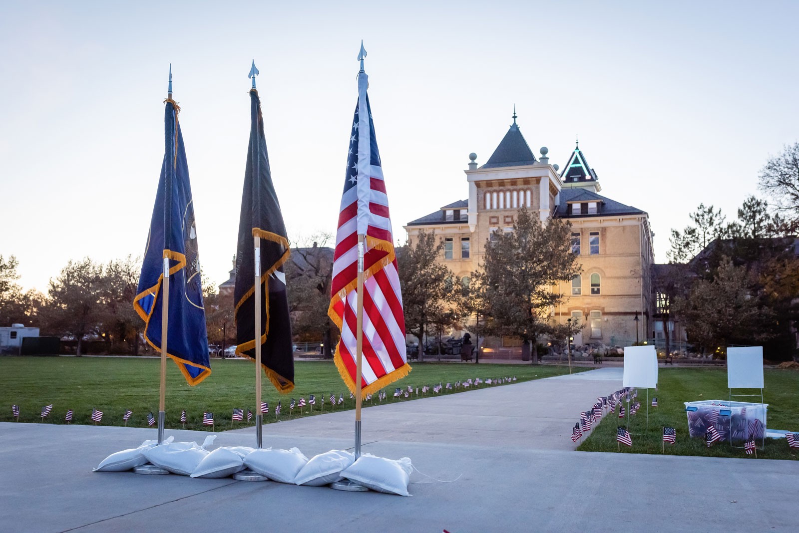 The Utah flag, the prisoner of war and missing in action flag, and the American flag on the USU Quad