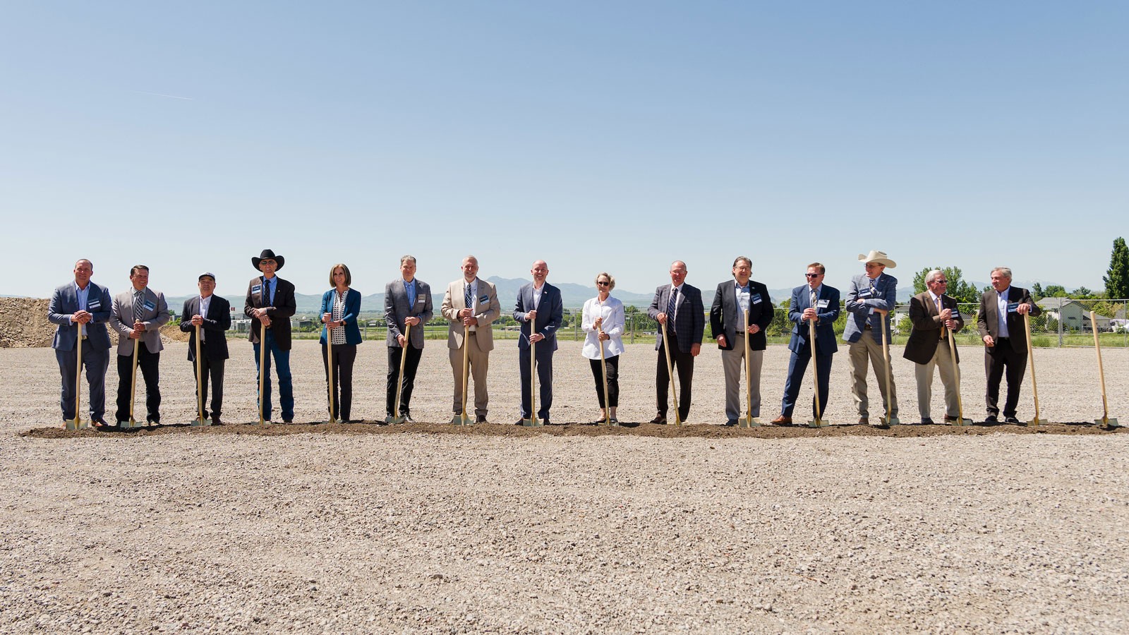 People with shovels posing for a photograph.