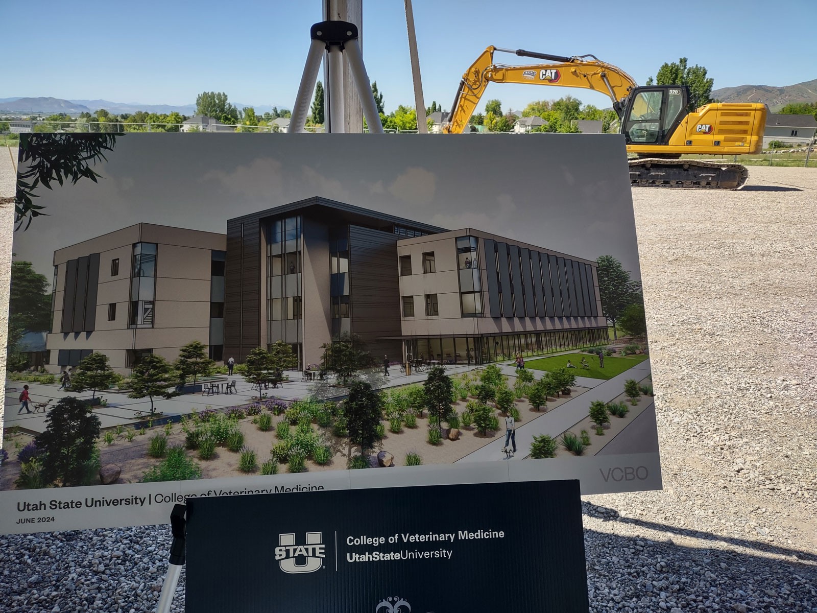 An architectural rendering sitting in front of a construction site.