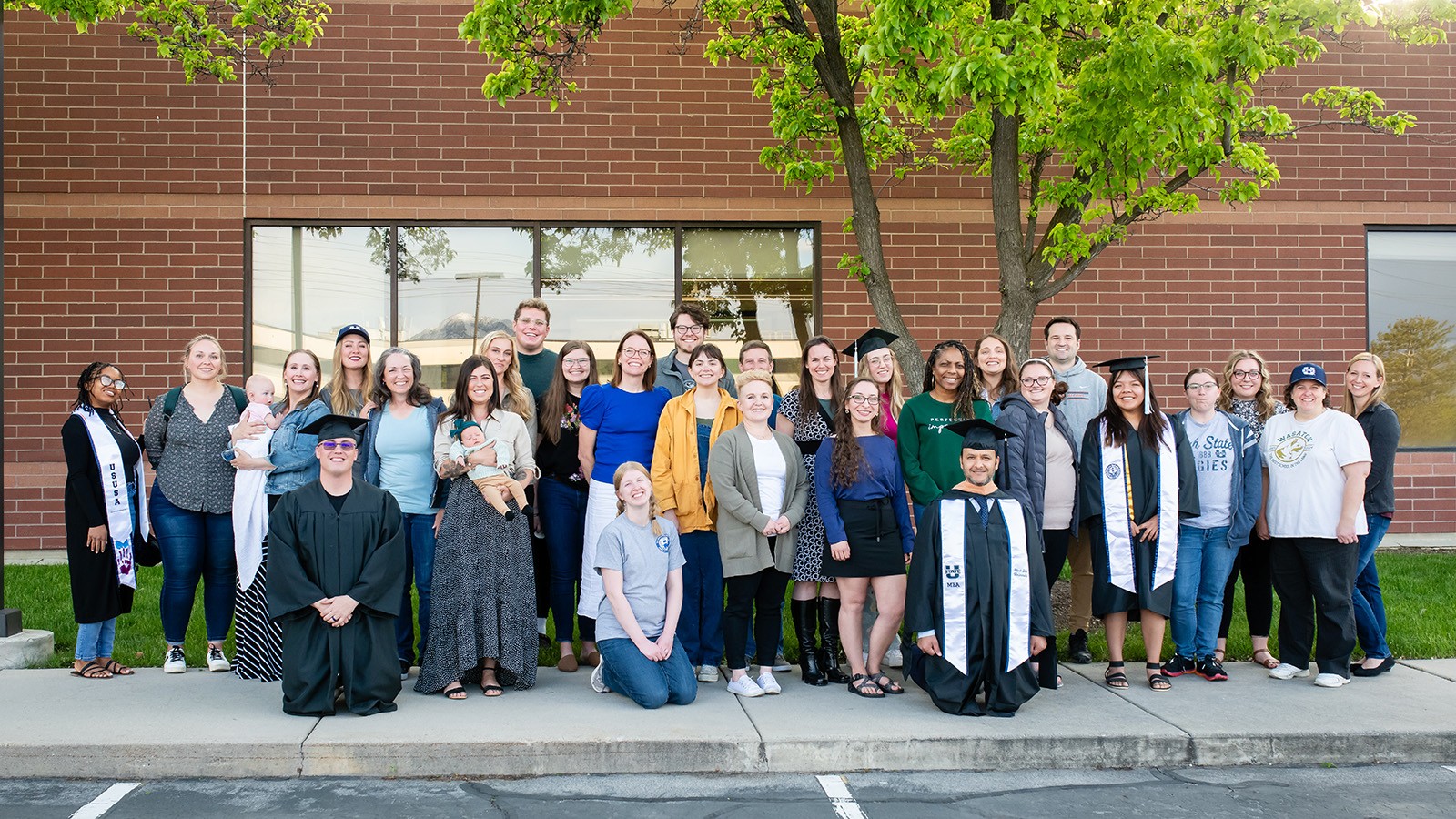 A group of graduates pose for a photo