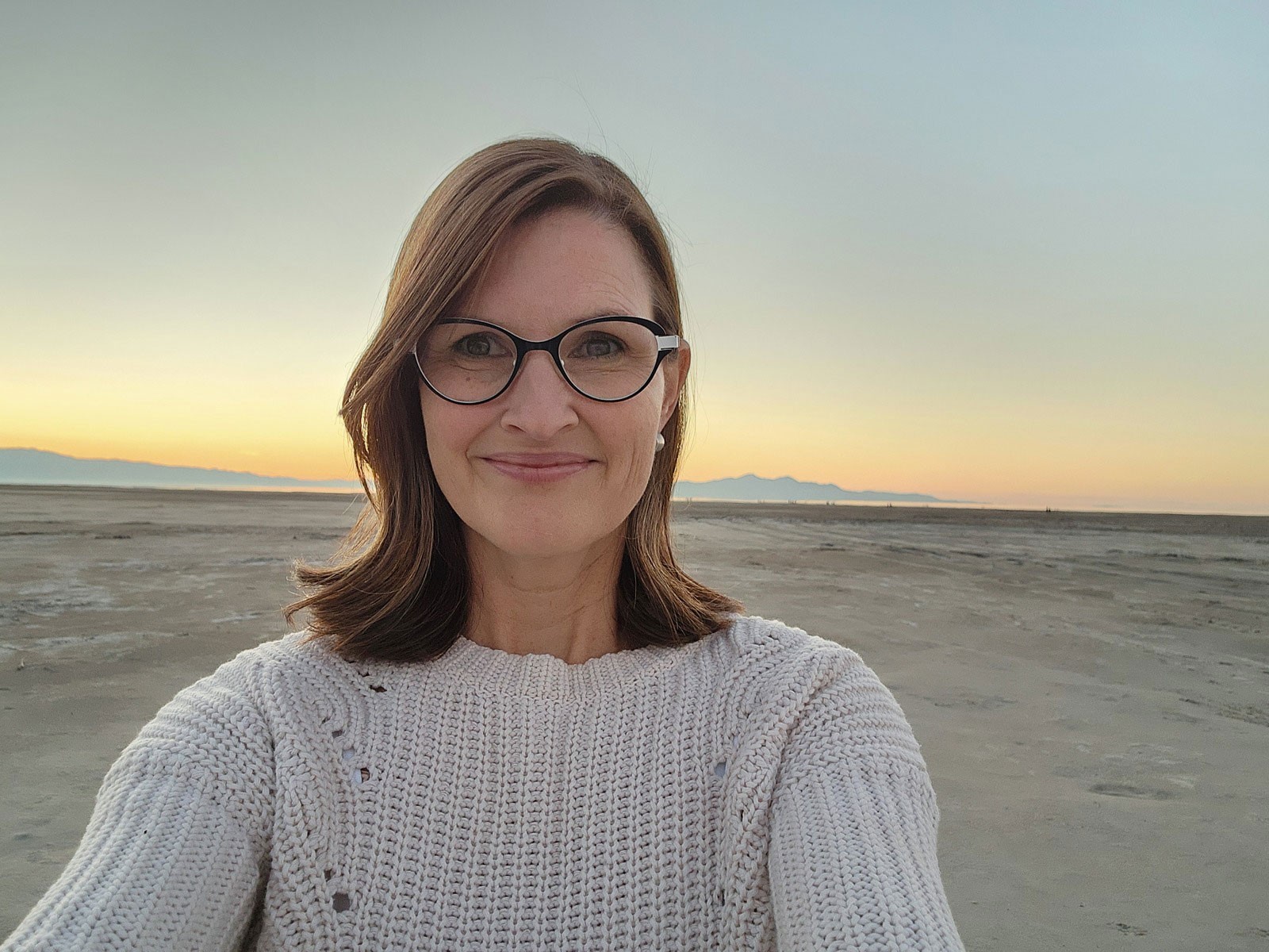 Amy Reid standing on a dry lakebed.