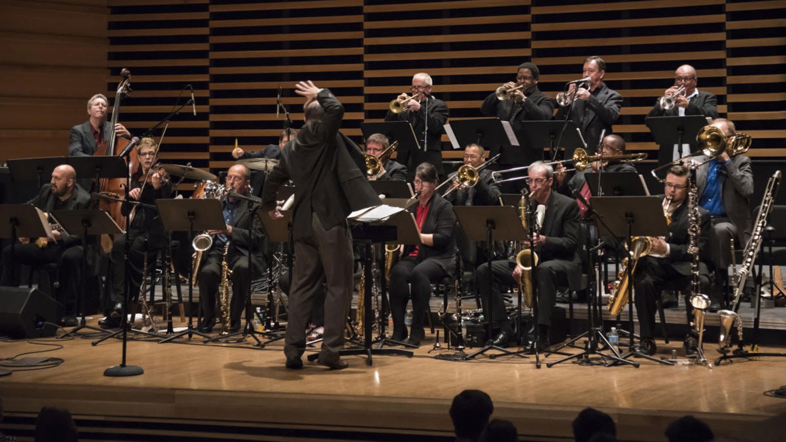 A large jazz ensemble performing onstage.