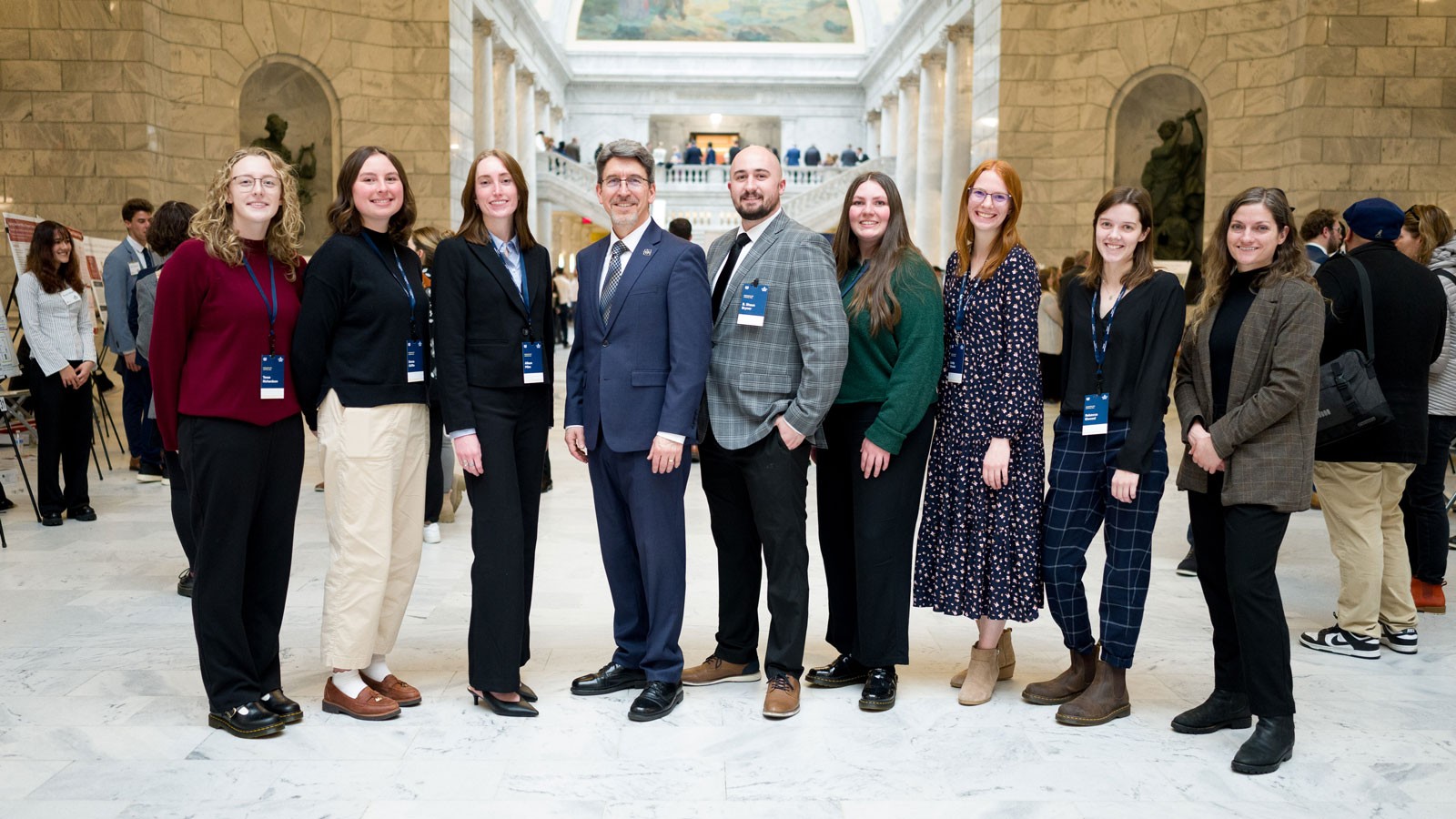 People posing for a photo in the Utah Capitol.
